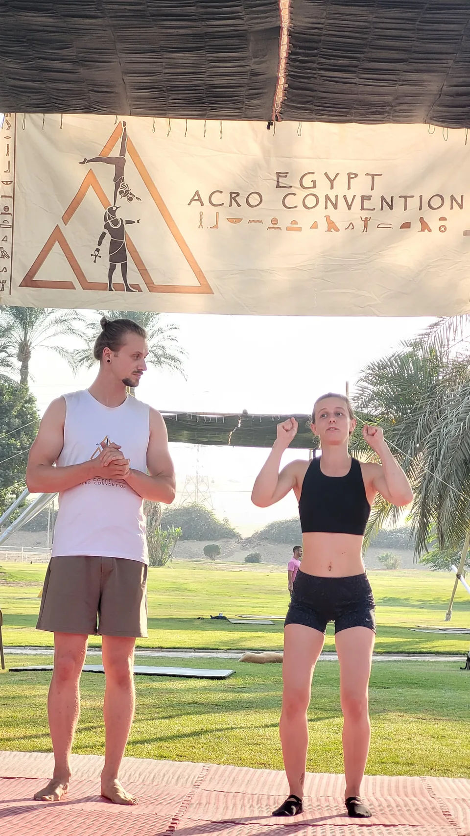 Josh and Cloe teaching beneath the EAC banner